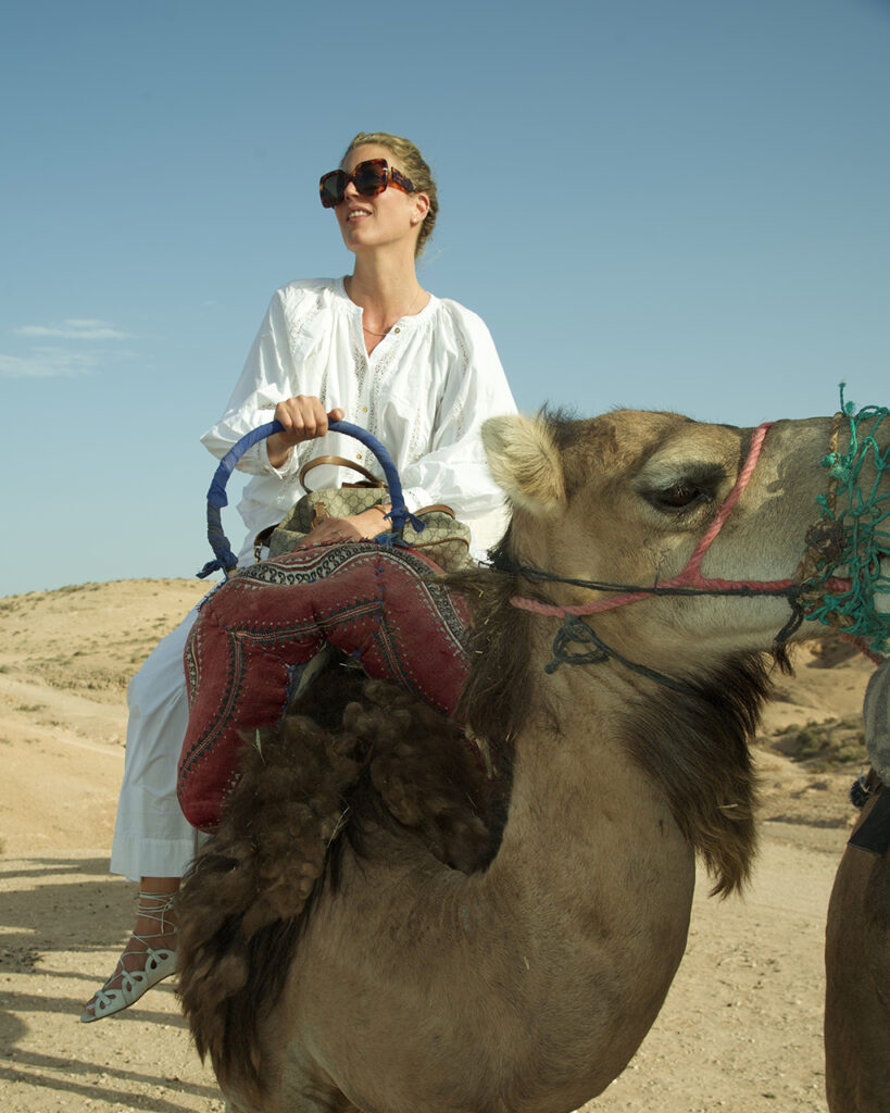 Tanja Gacic rides a camel in Morocco's desert